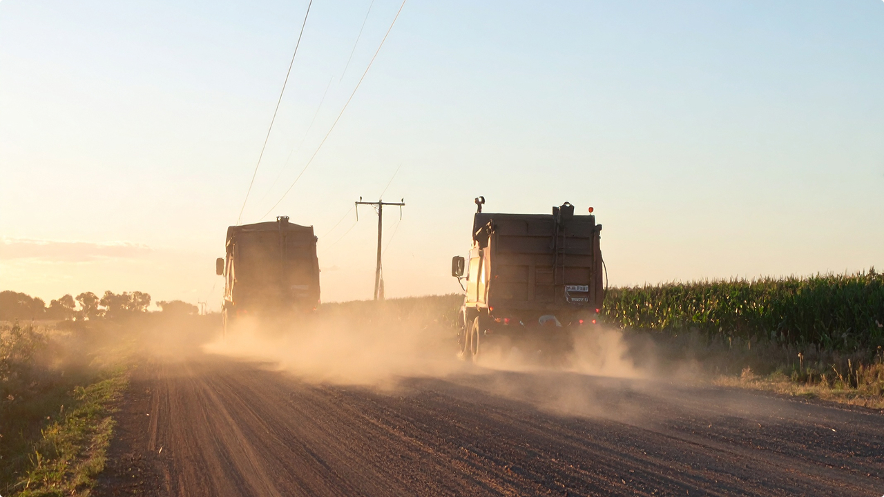 Firefly_Australian grain truck on a rural dirt road driving through harvested fields, sunset 652728 1